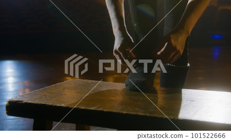 Ballet male dancer puts on ballet shoes 101522666