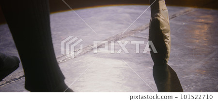 Close up leg of ballerina in pointe shoes spinning on tiptoe 101522710
