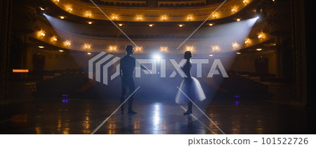 Classical ballet dancers practice on theatre stage 101522726