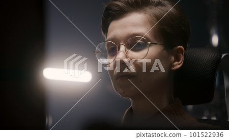 Female PC user looks on computer screen Female PC user looks on computer screen 101522936