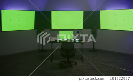 Computer and monitors with green screen in color correction studio 101522937