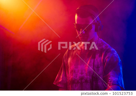 Club DJ playing music at party wearing sunglasses 101523753