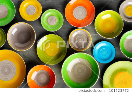 Color ceramic plates on gray background top view Color ceramic plates on gray background top view 101523772