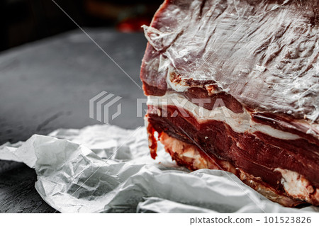 Raw T-bone steak cooking on stone dark table. Raw T-bone steak cooking on stone dark table. 101523826
