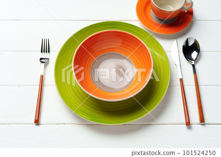 Top view of color ceramic plate on wooden background Top view of color ceramic plate on wooden background 101524250