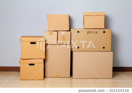 Cardboard boxes for moving on the floor against grey wall 101524338