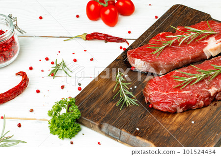Barbecue veal steaks with rosemary on wooden board 101524434