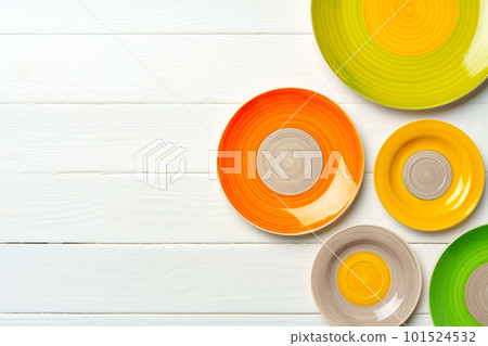 Top view of color ceramic plate on wooden background Top view of color ceramic plate on wooden background 101524532