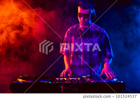 Club DJ playing music at party wearing sunglasses Club DJ playing music at party wearing sunglasses 101524537