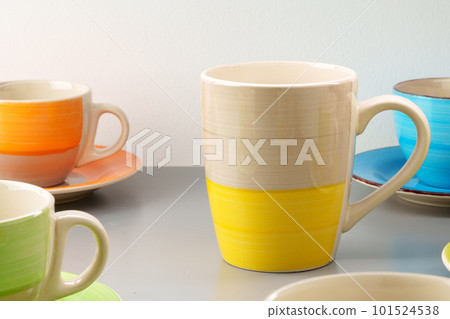 Colorful clay ceramic cups on gray background Colorful clay ceramic cups on gray background 101524538