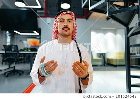 Young muslim man with rosary beads praying in the office Young muslim man with rosary beads praying in the office 101524542