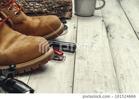 Hiking boots with travel accessories on grunge background 101524666