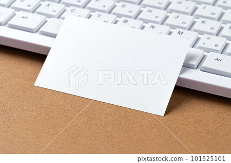Blank business cards with supplies and keyboard on office table. 101525101