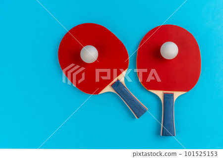 Red ping pong racket on a blue background Red ping pong racket on a blue background 101525153