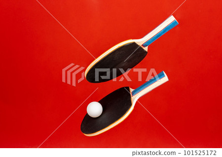 Black ping pong rackets on red background Black ping pong rackets on red background 101525172