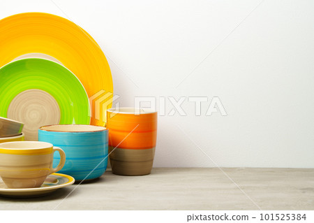 Set of colored ceramic dishware front view Set of colored ceramic dishware front view 101525384