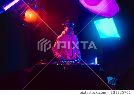 Male DJ playing music in the night club Male DJ playing music in the night club 101525761