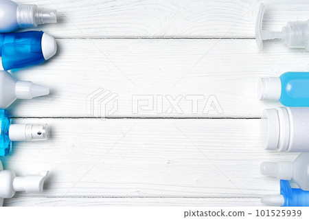 Row of bottles with hand sanitizers, liquid soap and medical preparations on wooden background Row of bottles with hand sanitizers, liquid soap and medical preparations on wooden background 101525939