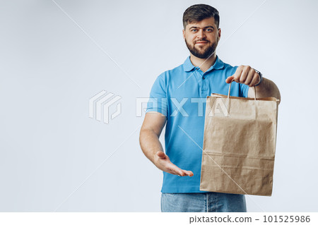 Food delivery courier with order on grey background 101525986
