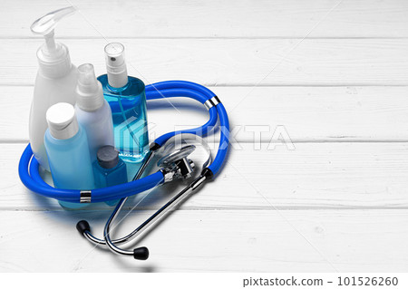 Hand sanitizer bottles on white wooden table 101526260