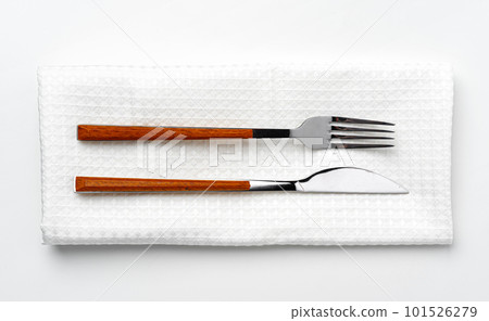 Set of fork and knife on towel. Isolated on white background. 101526279