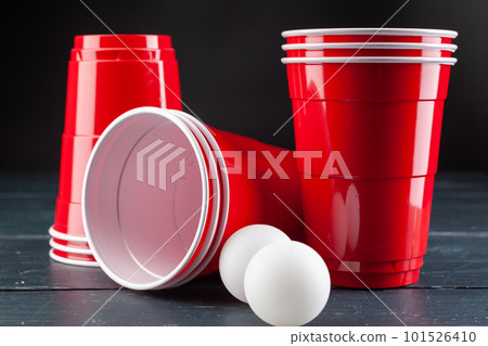 Wooden table with red cups and ball for beer pong Wooden table with red cups and ball for beer pong 101526410