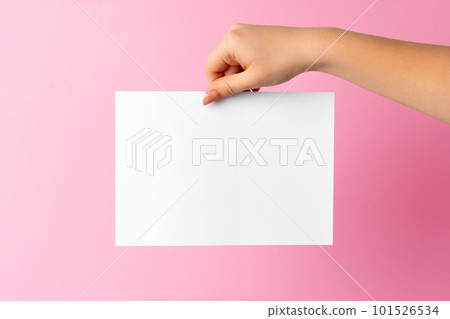 Woman hand showing blank business card on pink background. Woman hand showing blank business card on pink background. 101526534
