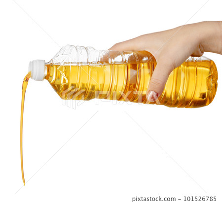 Hand of woman pouring cooking oil from plastic bottle. Isolated on white background. Hand of woman pouring cooking oil from plastic bottle. Isolated on white background. 101526785