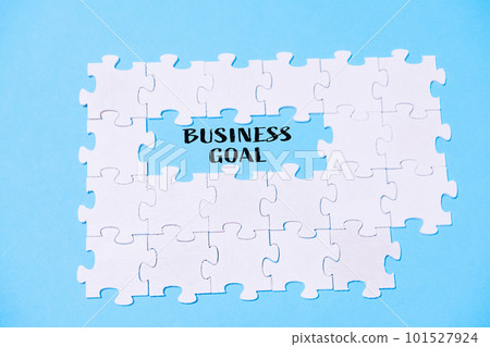 business text BUSINESS GOAL on a blue background with white puzzles 101527924