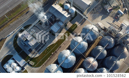 Grain elevator. Granary. Large metal structure grain elevator. Storage facility for grain. Top view. Grain storage. Silos. Metal hangar for cereal. Modern new elevator plant. agricultural agribusiness Grain elevator. Granary. Large metal structure grain elevator. Storage facility for grain. Top view. Grain storage. Silos. Metal hangar for cereal. Modern new elevator plant. agricultural agribusiness 101528562
