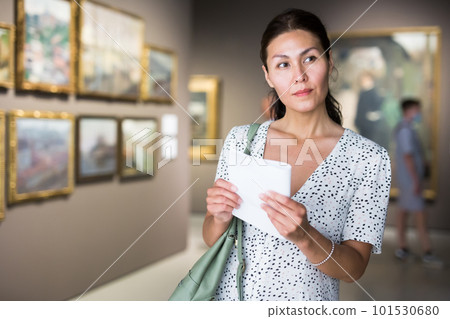 woman admiring art work woman admiring art work 101530680