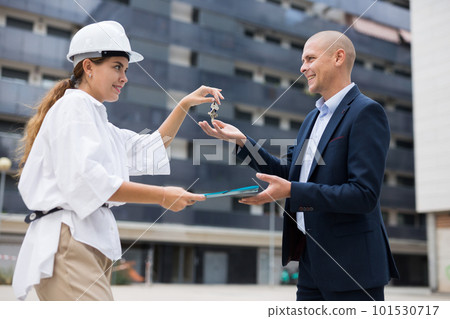 Builder giving keys to client after finishing signing contract Builder giving keys to client after finishing signing contract 101530717