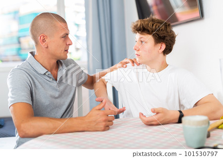 Dad and teenager son having conversation 101530797