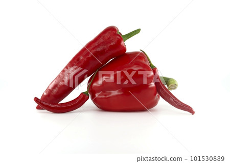 Fresh chili peppers and red bell peppers over white 101530889