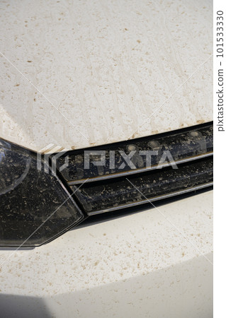 The front grill of a car stained with yellow dust The front grill of a car stained with yellow dust 101533330