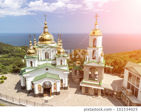Christian church in the mountains above the sea. Temple of the Holy Archangel Michael in Oreanda. The southern coast of Crimea. Aerial view 101534025