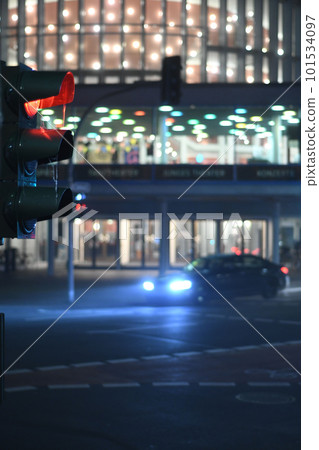 Vertical shot of the German traffic light showing red. Blurred lights in the background. Muenster, Germany. 101534097