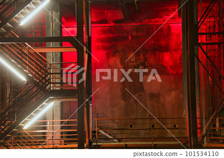 Red illuminated metal staircase at night on the site of the Zollverein colliery in Essen, Germany 101534110