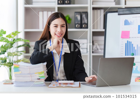 Asian Business person makes analysis and research financial report at office, analyzes profits. Accountant checks status of financial Asian Business person makes analysis and research financial report at office, analyzes profits. Accountant checks status of financial 101534315