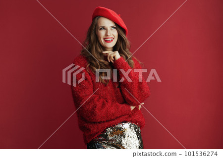 smiling modern woman in red sweater and beret 101536274