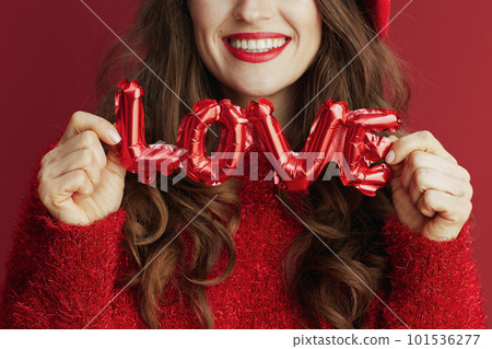 Closeup on woman in red sweater and beret 101536277