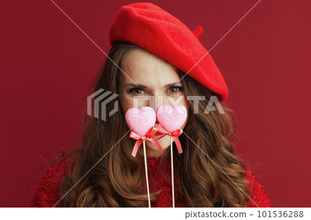 trendy 40 years old woman in red sweater and beret 101536288