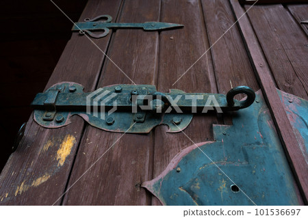 Old iron bolt on the wooden door 101536697