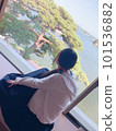 A woman watching the view from the window 101536882