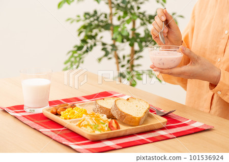 Senior woman eating bread breakfast 101536924