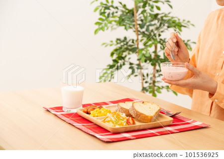 Senior woman eating bread breakfast 101536925