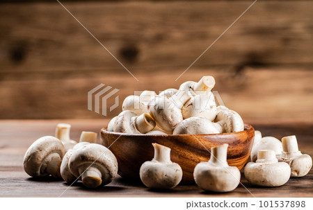 A wooden plate full of fresh mushrooms. A wooden plate full of fresh mushrooms. 101537898