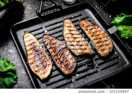 Slices of eggplant in a grill pan. Slices of eggplant in a grill pan. 101538997