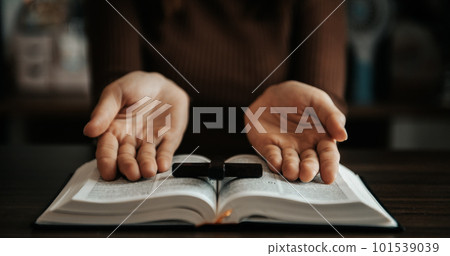 Woman praying on holy bible in the morning.Woman hand with Bible praying. Christian life crisis prayer Woman praying on holy bible in the morning.Woman hand with Bible praying. Christian life crisis prayer 101539039