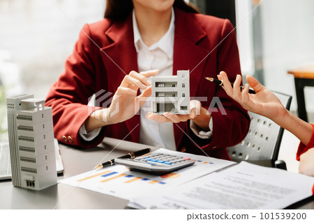 Signing a contract. Client and broker agent, lease agreement, successful deal and Young business sitting at the desk Signing a contract. Client and broker agent, lease agreement, successful deal and Young business sitting at the desk 101539200